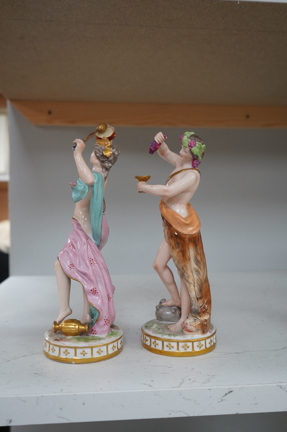 A pair of German porcelain figures, 22cm. Condition - fair to good